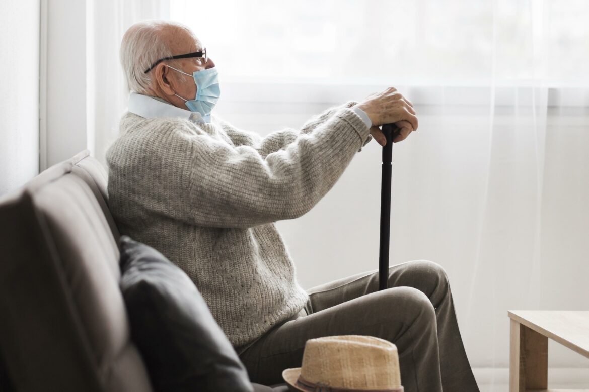 side-view-of-old-man-with-medical-mask-in-nursing-home